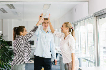 Obraz premium Group of business professionals giving each other a high-five