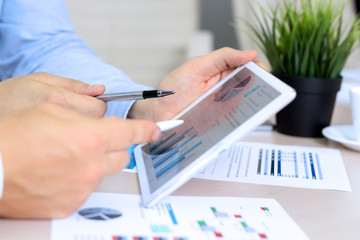 Business colleagues working and analyzing financial figures / gr