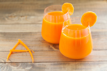 Carrot juice in glass on  table