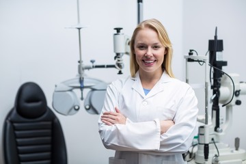 Female optometrist standing in clinic