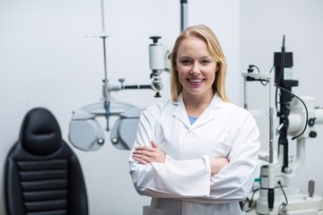 Female optometrist standing in clinic