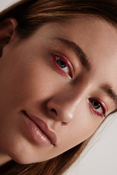 woman with a creative colored red lashes
