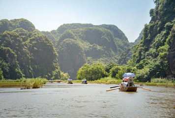 Fototapeta na wymiar Tourists asia traveling in boat along nature the river and mountain