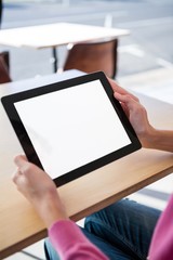 Woman using a digital tablet in the coffee shop