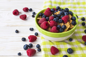 Healthy corn flakes breakfast on the white wooden table