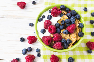 Healthy corn flakes breakfast on the white wooden table