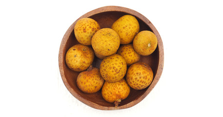Longan in wood bowl macro photo top view