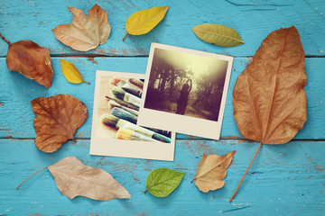 Fototapeta na wymiar Autumn background with dry leaves and old photo frames
