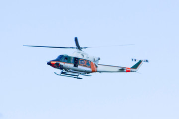 Fototapeta na wymiar White-orange helicopter is flying