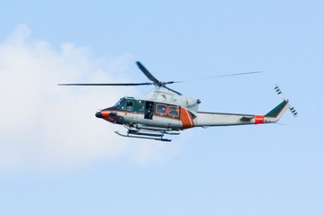 White-orange helicopter is flying