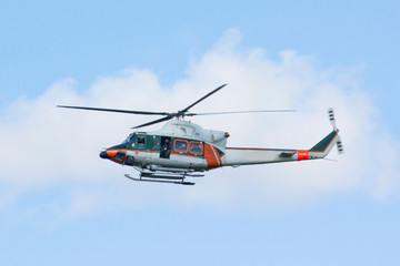 White-orange helicopter is flying