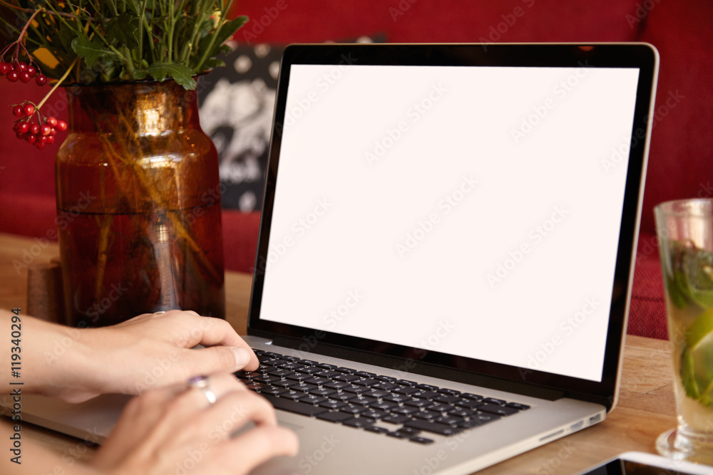 Aufkleber female hands typing on keyboard of laptop computer while surfing internet and texting friends via so