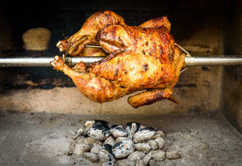 Cooking rotisserie chicken on the grill with Charcoal and Brique