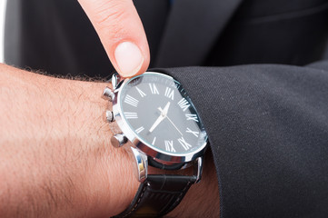 Male manager pointing watch in closeup