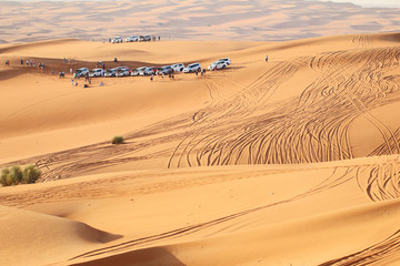 Fototapeta na wymiar Traveler car and people on a desert safari
