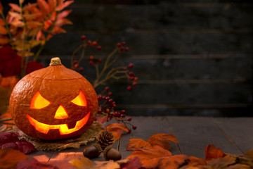 Burning Jack O'Lantern on a rustic table