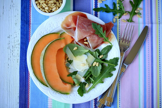 Salad with prosciutto, melon, arugula & pine nuts