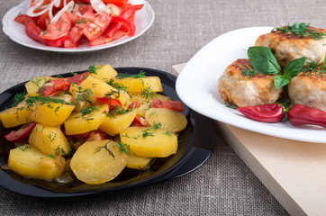 Stewed potatoes, meatballs minced chicken and a salad of fresh t