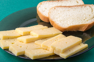 Pieces of yellow hard dry cheese and white bread slices