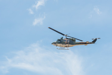 Naklejka na ściany i meble Army helicopter on blue sky.