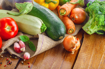 Organic vegetables for healthy food cooking. Fresh ingredients on a rustic wooden table.