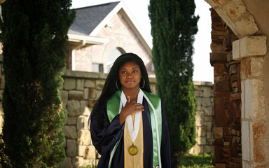 Beautiful African-American graduate in modern neighborhood environment 
