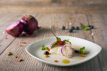 delicious codfish with onions, selective focus