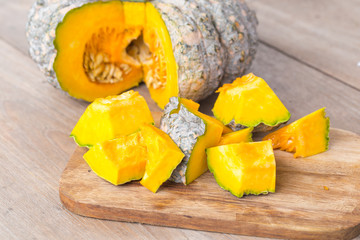 Slice of pumpkin on a wooden table