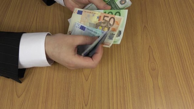 Officer man take and count euro banknotes. 4K