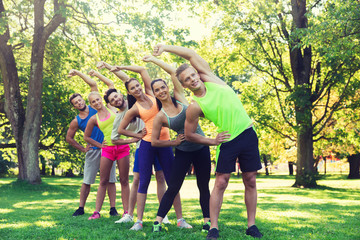 group of friends or sportsmen exercising outdoors