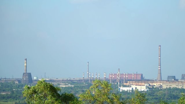 Landscape at the metallurgical plant. Pipes and steel plant building