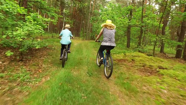 Family bike riding on forest 