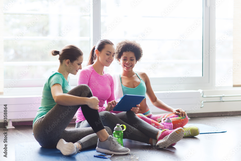 Wall mural group of happy women with tablet pc in gym