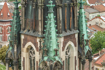 Naklejka premium Detail of the tower of the Church of Saints Olga and Elizabeth on a background of Lviv roof