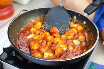 Chef cooking Thai style food with mushroom