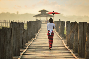 The beautiful woman Myanmar in during sunrise , Ubein bridge, Mandalay Myanmar,vintage style