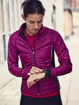 Young runner looking at watch