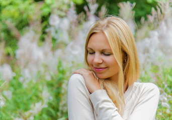 Naklejka premium Young, charming, beautiful woman in gentle atmosphere feels the touch of an angel on her shoulder. Outdoor portrait.