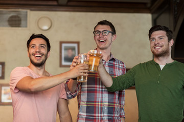 happy male friends drinking beer at bar or pub
