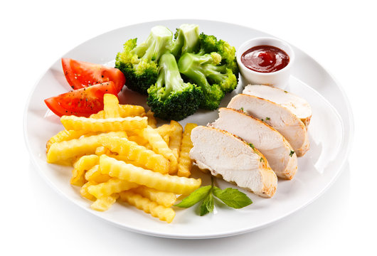 Grilled chicken fillet and vegetables on white background 