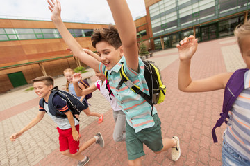group of happy elementary school students running