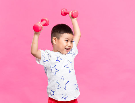 Little Kid Lifting Up Dumbbell