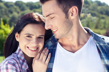 Portrait of happy couple laughing at camera