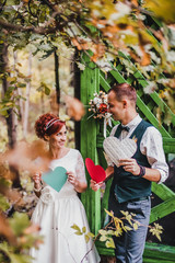 Loving young couple on a date with flowers and with a gift in the park