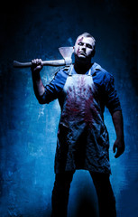 Bloody Halloween theme: crazy killer as bloody butcher with an ax