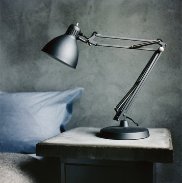 A lamp on a bedside table.