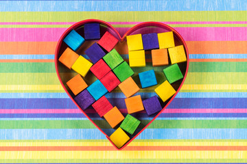 Gay pride. Rainbow colored wood pieces in metal shaped heart.