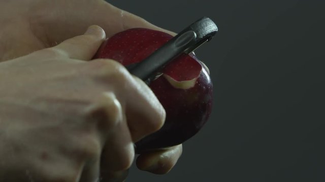 Peeling a red apple