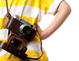 Little boy holding the photo camera on the shoulder