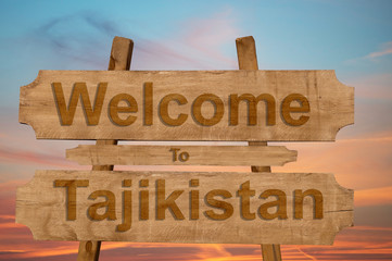 Welcome to Tajikistan sing on wood background